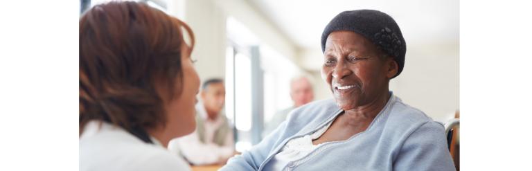 A nurse talking to a patient in wheelchair